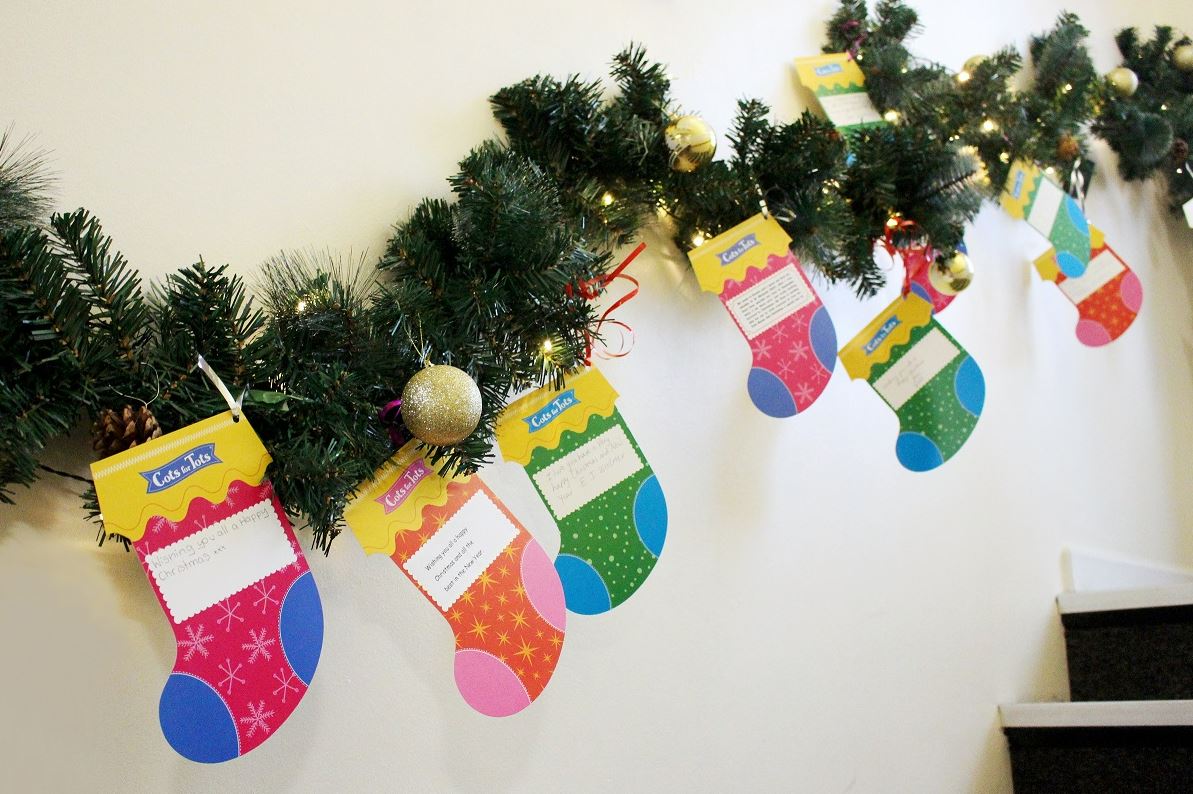 christmas-stockings-hanging-off-wreath
