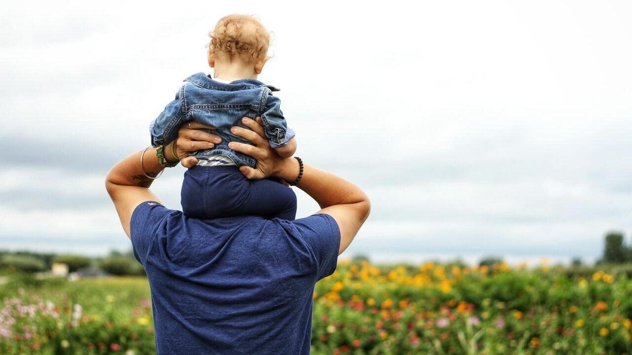 back-view-of-man-holding-child-on-shoulders