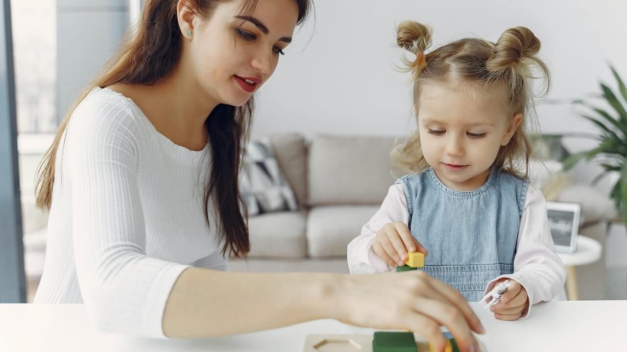 dark-haired-woman-playing-with-young-girl
