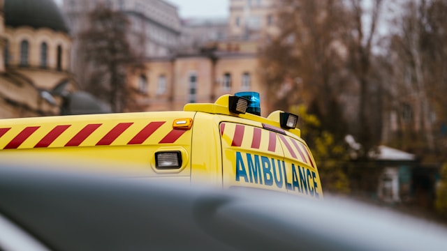 top-of-yellow-ambulance-against-buildings