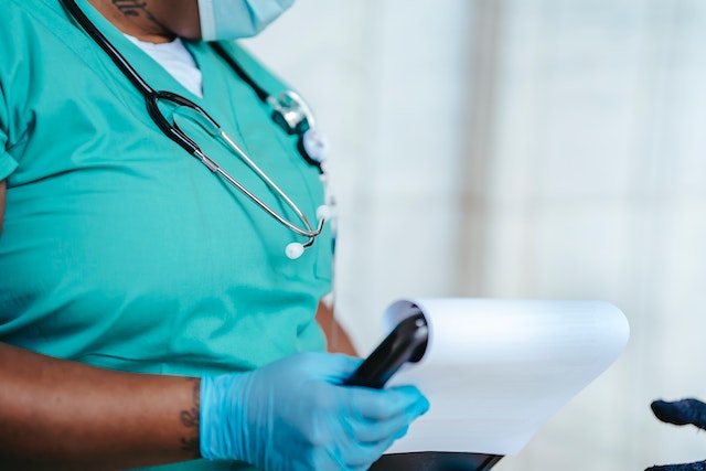 close-up-of-black-woman-in-medical-scrubs-holding-clipboard