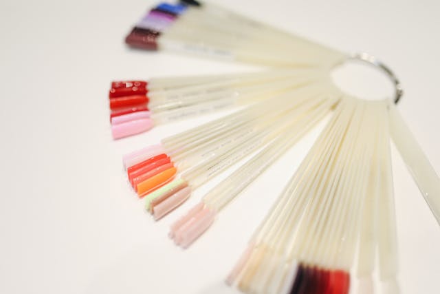 A set of nail polish colour samples arranged on a plastic ring