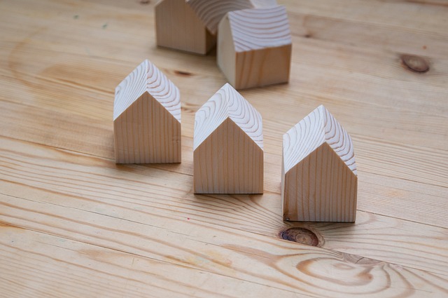 Wooden toy houses on light wood table top