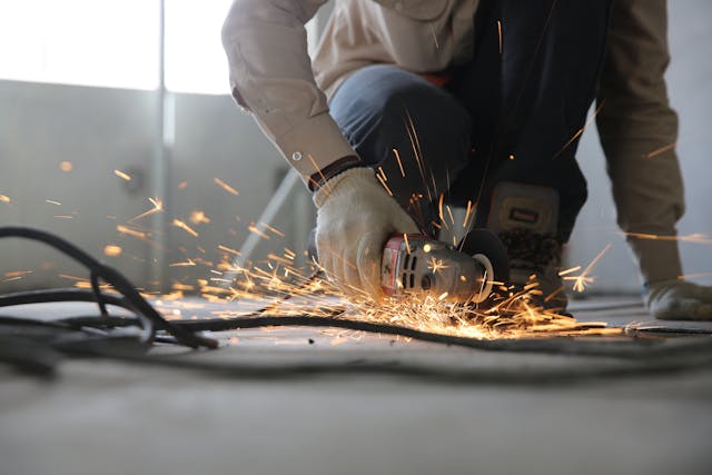 Man using power tool wearing gloves