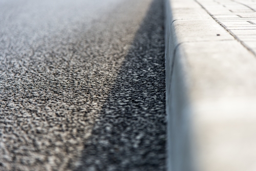 Close up of grey pavement kerb