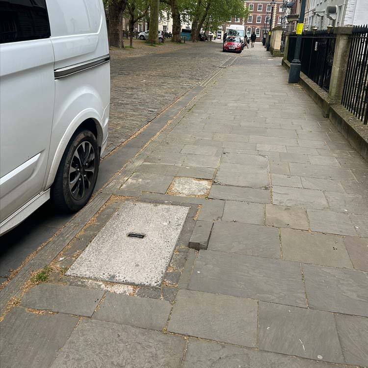 A loose paving slab on a pavement