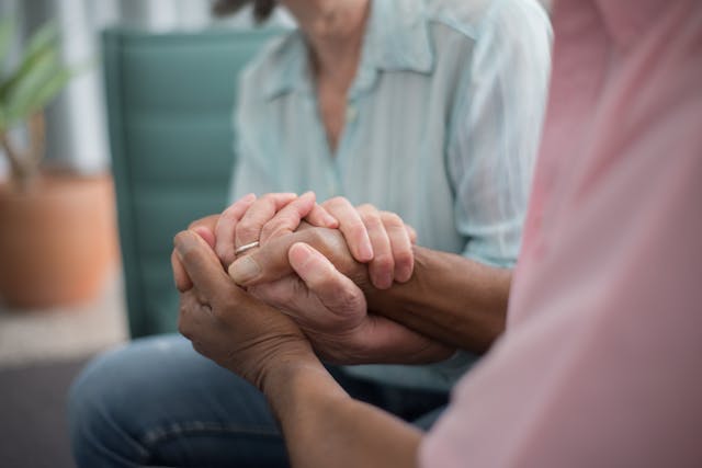 Elderly couple holding hands