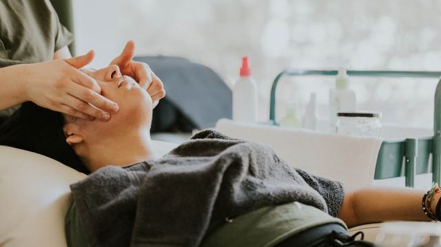 A woman receiving a facial treatment