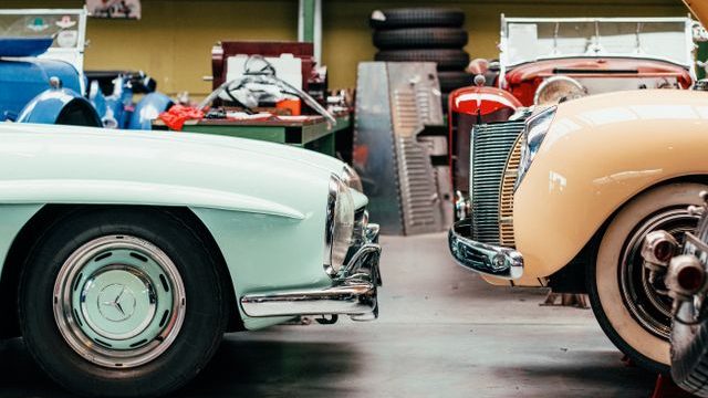 Classic cars inside a vintage auto workshop