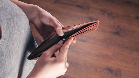 View of woman opening empty wallet
