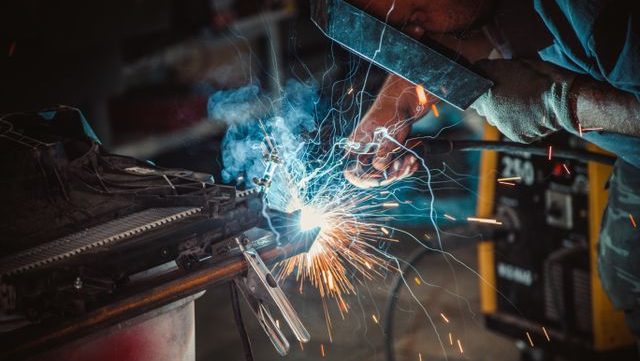 Close up of a welder using equipment