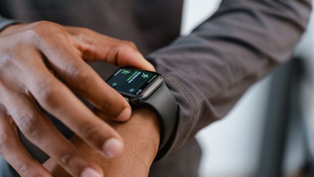 A detailed view of a smartwatch tracking fitness on a person's wrist